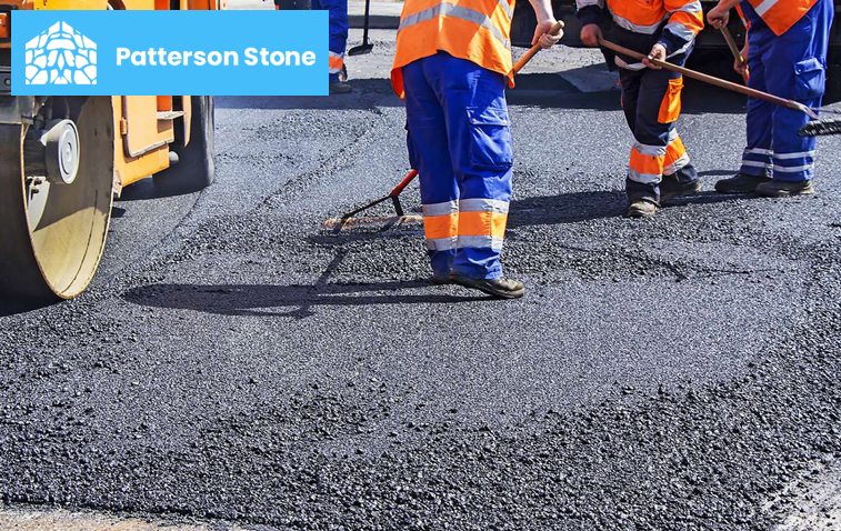 Workers laying asphalt for a smooth driveway surface.