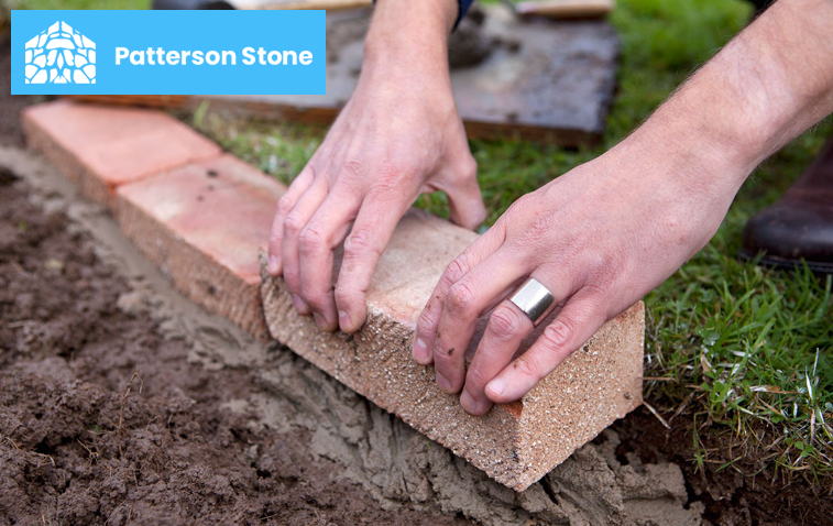 Close-up of brick installation work in a garden landscaping project.