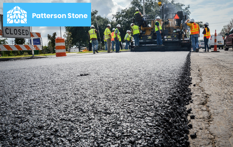 Workers installing asphalt paving on the driveway